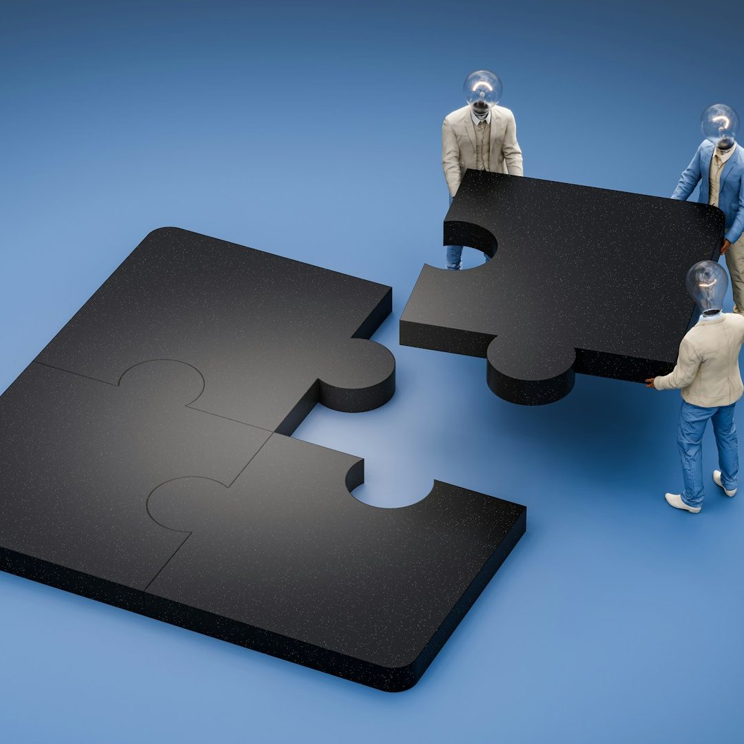 Miniature figures place a puzzle piece