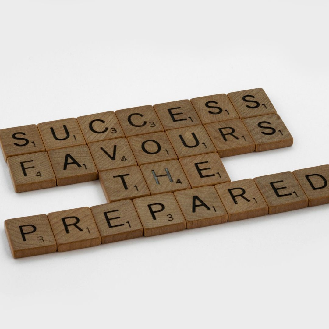 Acrabble pieces spelling out "Success favours the prepared"